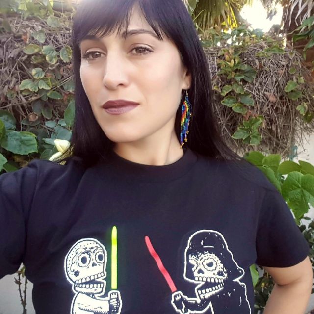 Woman wearing black shirt smiling.